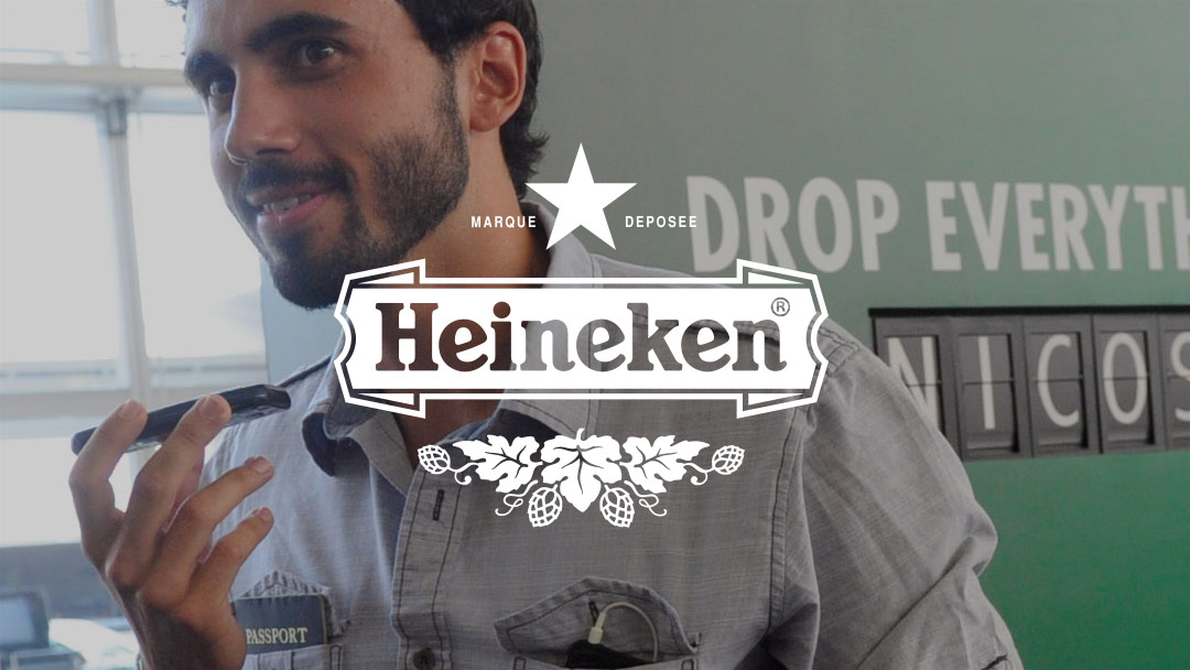 Heineken logo over bearded man talking into his mobile phone