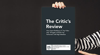 Person holding a report called "The Critic's Review"