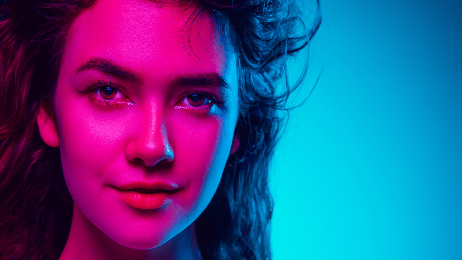 Girl face in pink and blue neon light